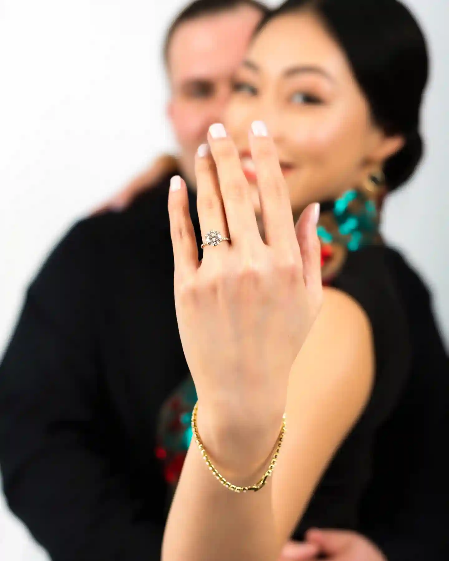 couple showing a diamond engagement ring